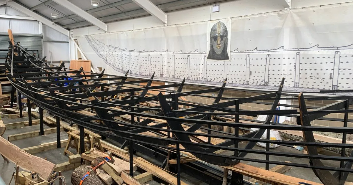 Inside the LongShed in Woodbridge Suffolk the frame of a longboat being constructed by hand.