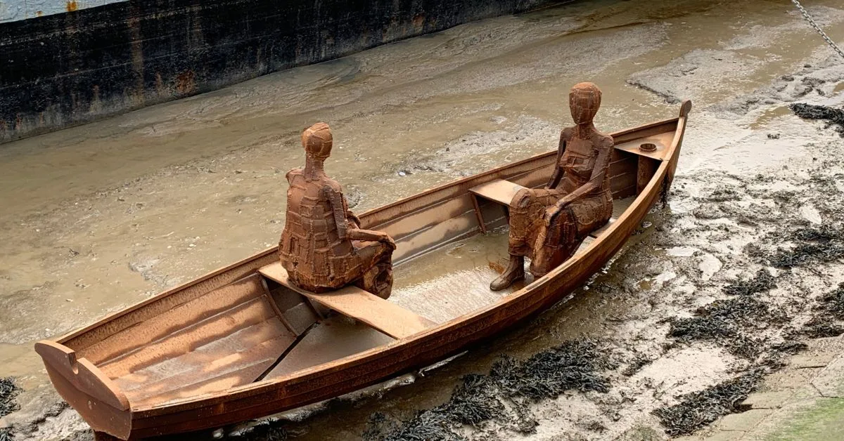 Sisters Sculpture by Andrew Baldwin shows two women sitting in a small rowing boat facing each other. It can get submerged at higher tides.