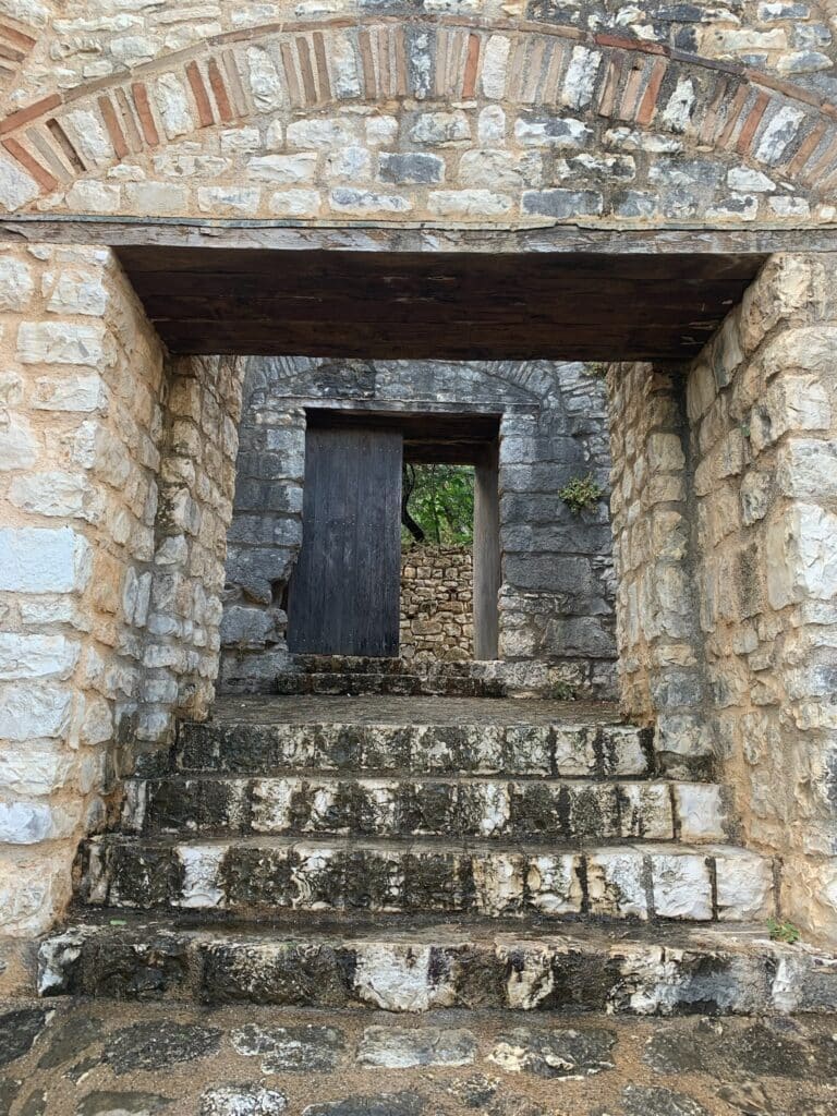 A stone arch forms an entry to a castle in Corfu.