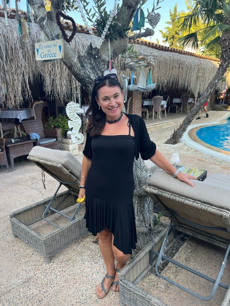 Woman standing at a pool area in Halkidiki Greece