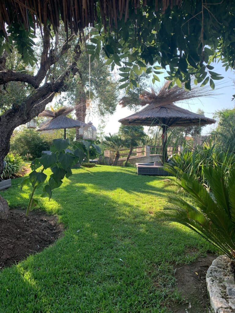 The grounds of a hotel in Halkidiki with large areas of green manicured lawns.
