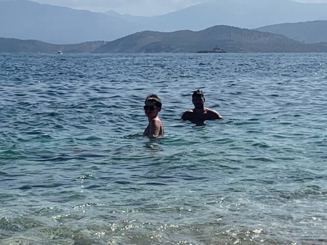 2 People swimming in the ocean in Greece