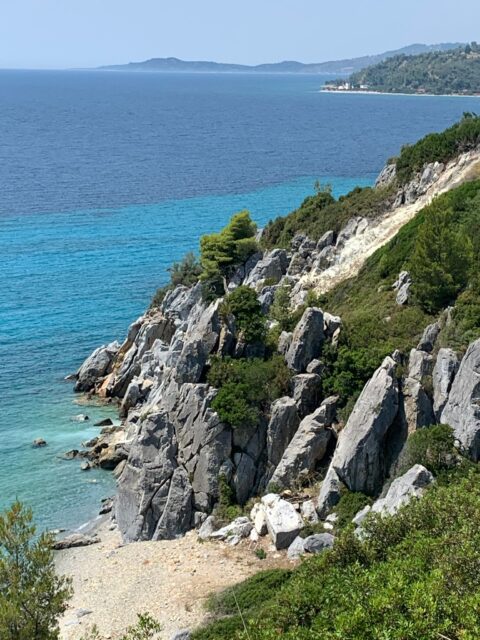 A cliff side leading down to a beach in Greece in a remote area of Halkidiki