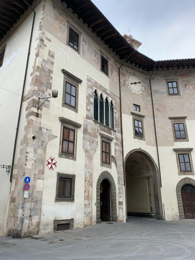 Tuscan styled stone building with decor on front stones.