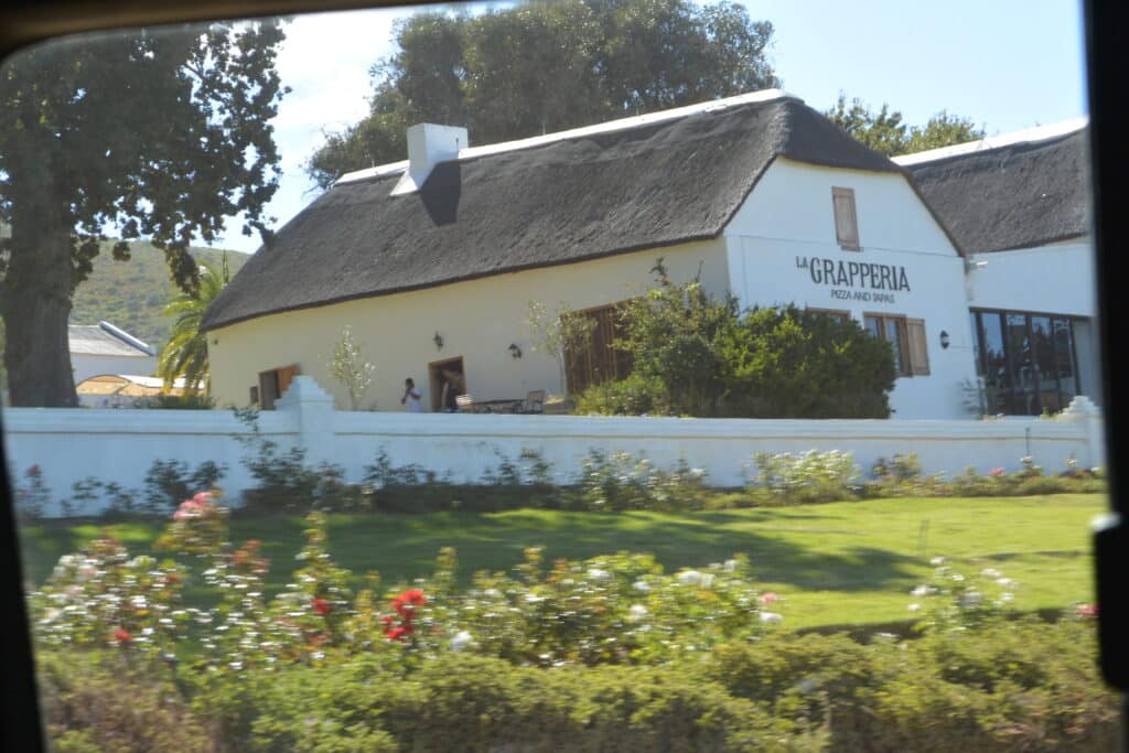 A whitewashed building and winery tasting shed.