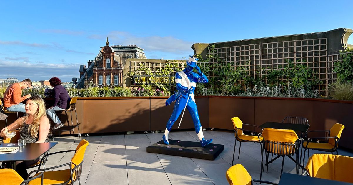 People sitting on a rooftop bar at Johnny Walkers Visitor Center in Edinburgh.