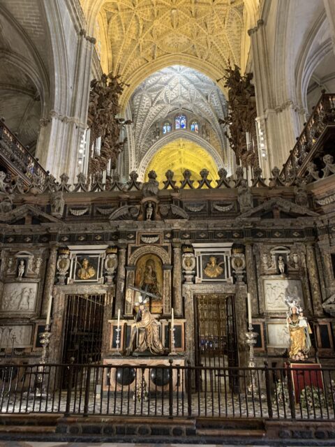 Altar area and dome ceiling inside Seville Cathedral.