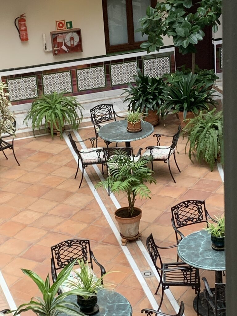 A courtyard with seating and foliage decor within the lobby area of a hotel.