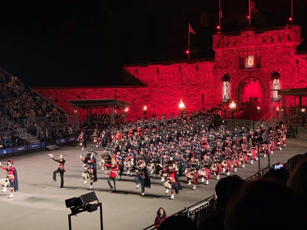 Bright red lighting shines down on pipers at Edinburgh Castle Show in Scotland.