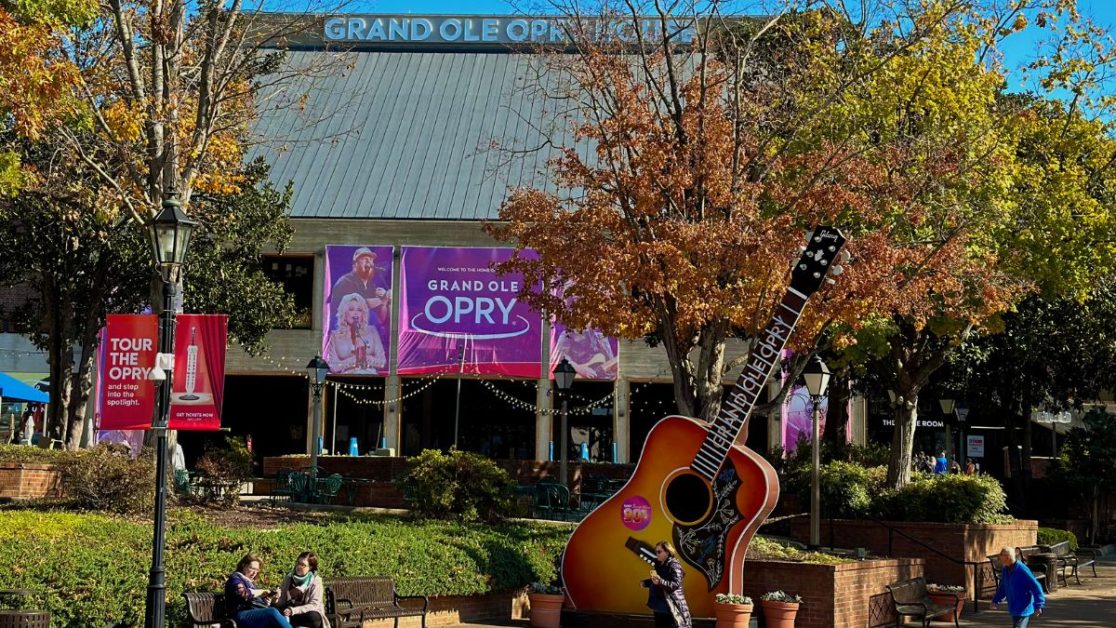 Oversized guitar and large signage in front of the entrance to the Grand Ole Opry in Nashville.