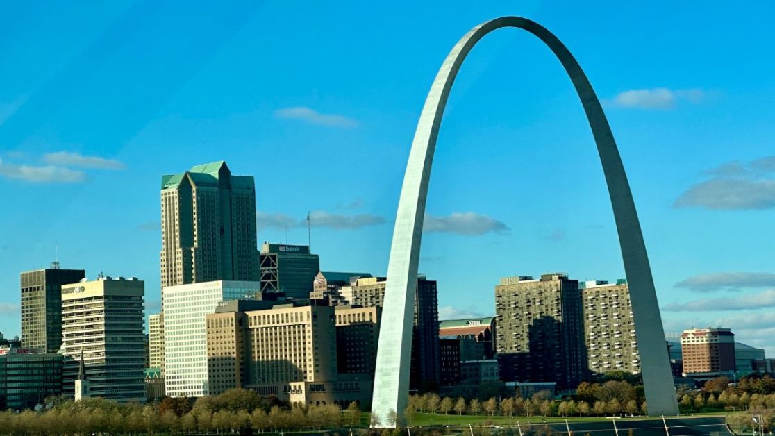A skyline of downtown St Louis with the famous Gateway Arch and park.