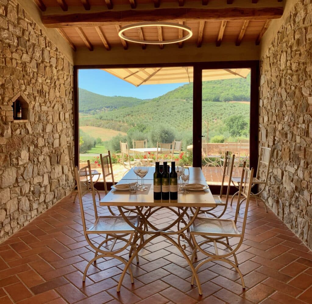 A dining area with views out over the Tuscan valleys.