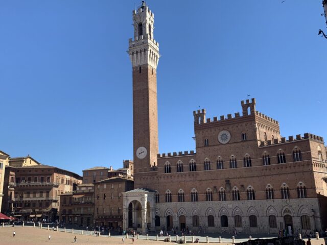 Siena on our tour of italy itinerary has an enormous red brick style square with a high clock tower. Races are held in the square annually.