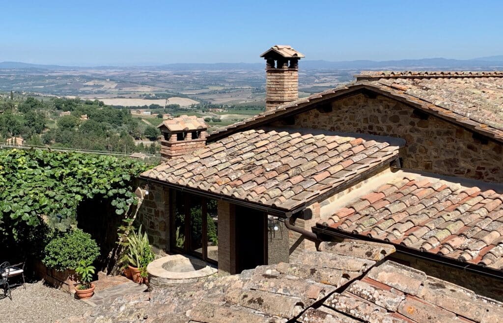 Rooftops on a Winery in Tuscany show views out over rolling hills, green and fertile.