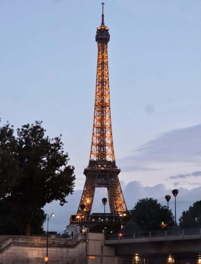 Illuminated lights decorate the entire Eiffel Tower in Paris at night.
