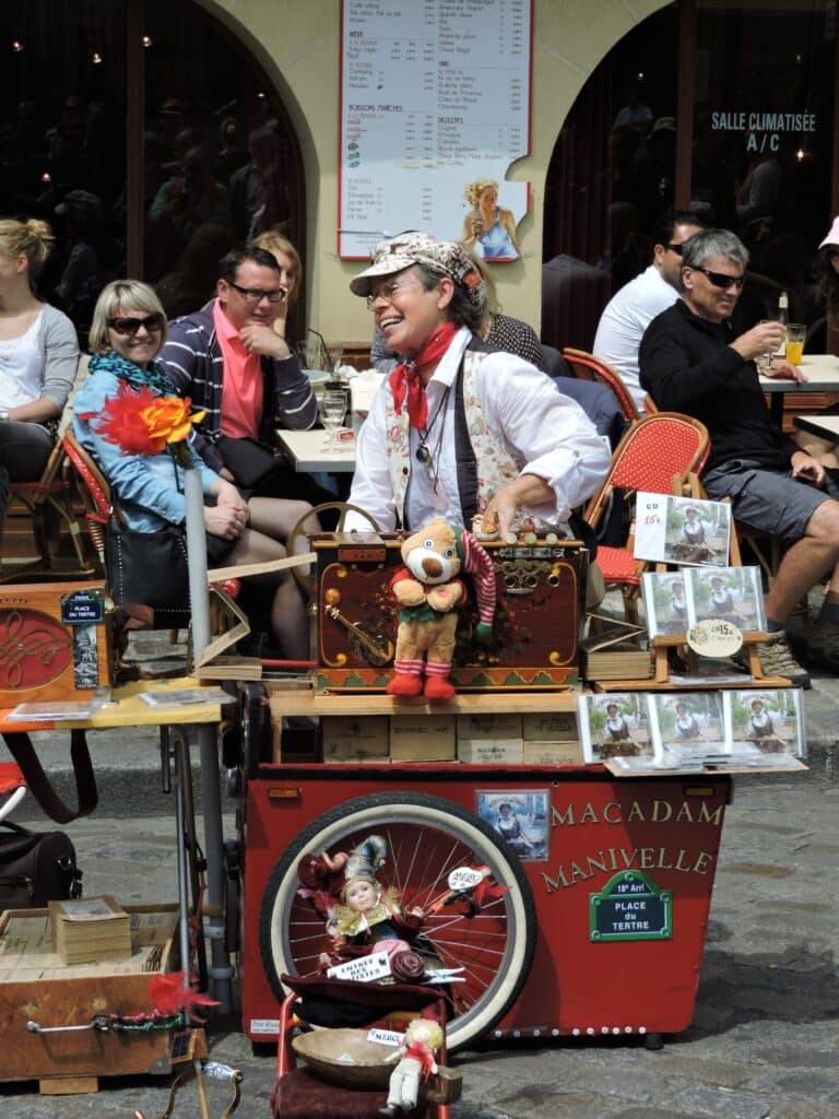 Street performer in Paris with an old monkey organ.