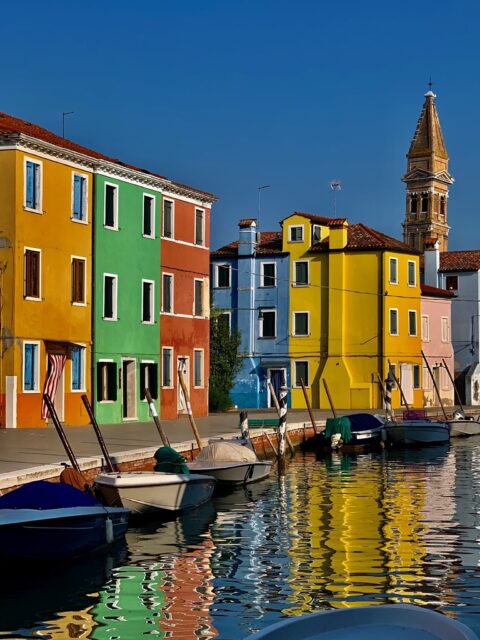 Brightly painted houses on canals in Burano an island near Venice and worth including on any tour of italy itinerary