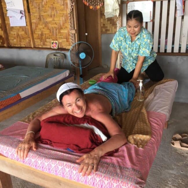 Woman lying on a massage table, receiving a Thai massage which is one of the highlights of Krabi.