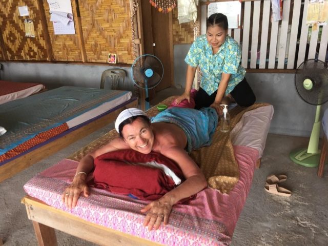 Woman lying on a massage table, receiving a Thai massage which is one of the highlights of Krabi.