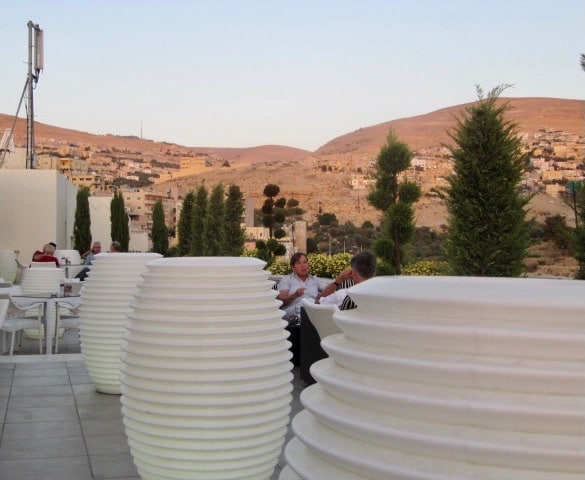 Large ceramic pots on a hotel terrace overlooking the desert of Jordan.