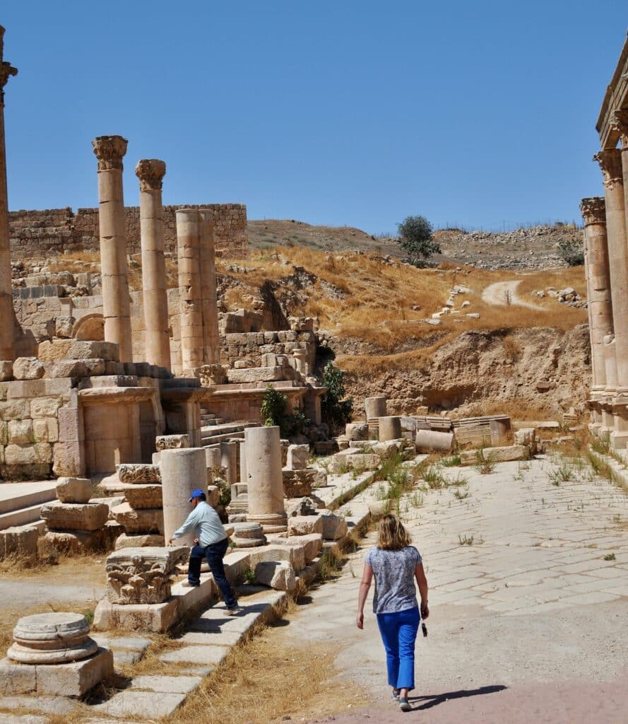 Woman walking around ancient ruins in Amman.