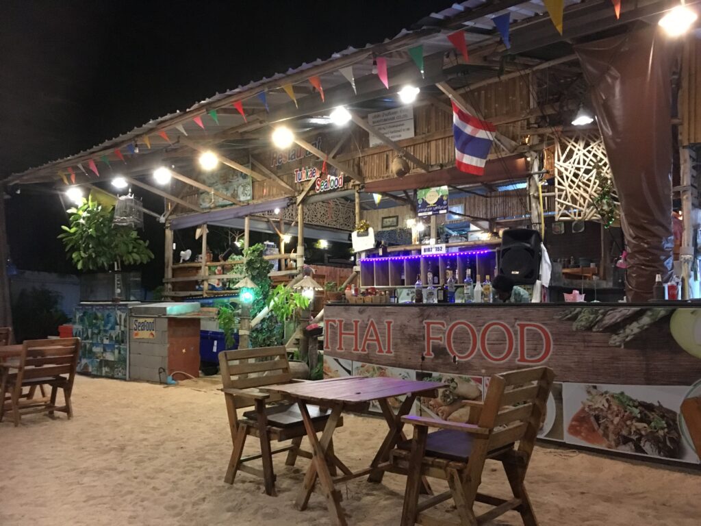 Evening dining on the beachfront with tables set for dinner.