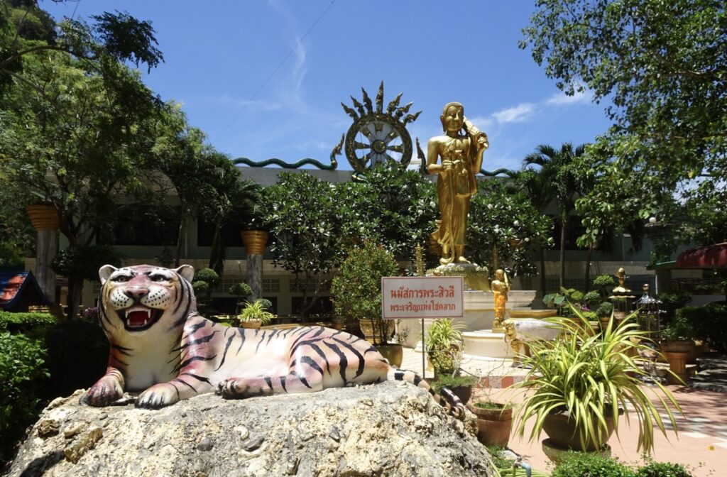 Tiger statue is at the entrance to a temple.