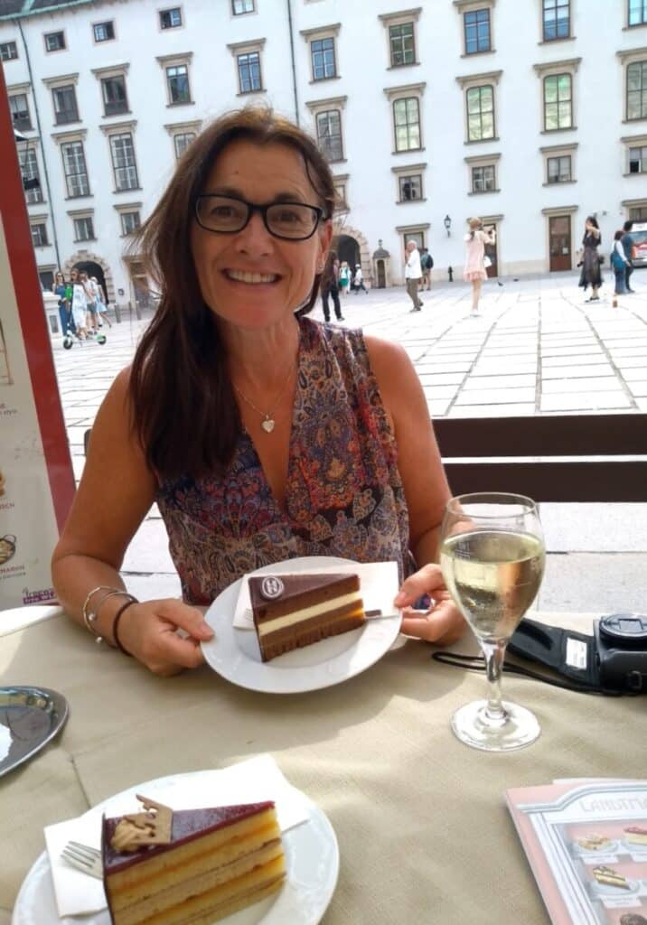Woman eating cake in an Austrian cafe in Vienna.