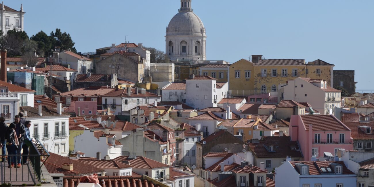 Views of the city of Lisbon with multi coloured buildings and rooftops.