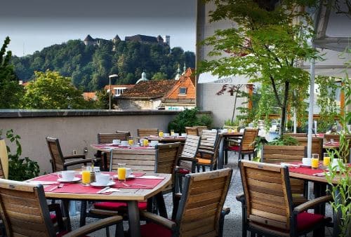 Tables are set for leisurely breakfast outdoors in Ljubljana Slovenia.
