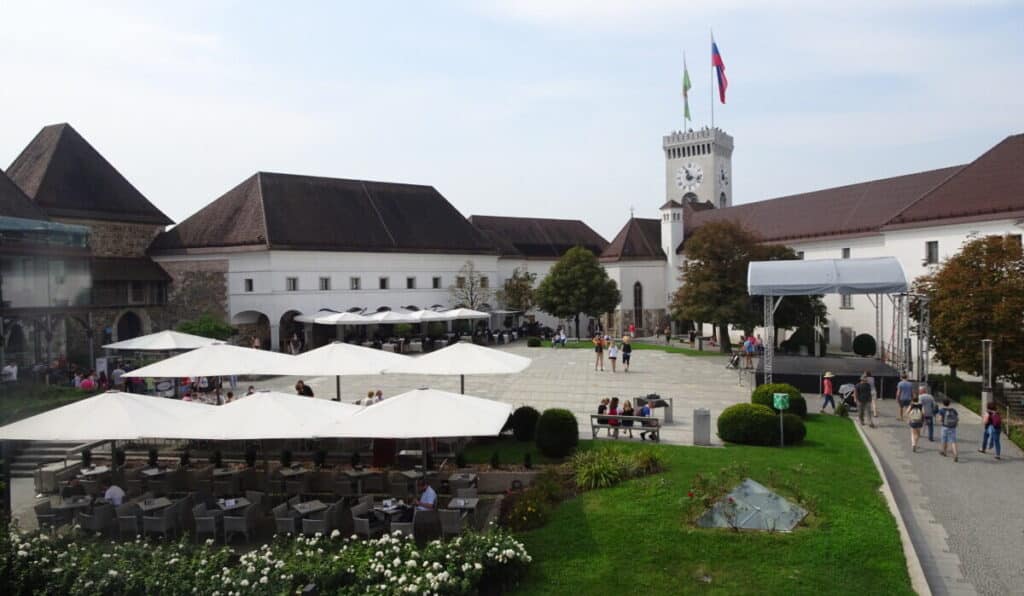The courtyard with grass area and outbuildings which are part of the main castle in Ljubljana.