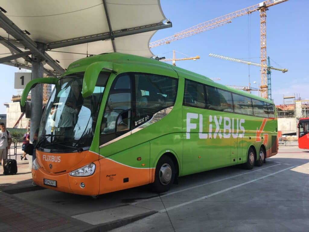 A tourist bus - Flixbus - painted green and orange.