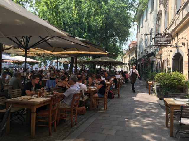 A line of seating in outdoor cafes in Slovenia