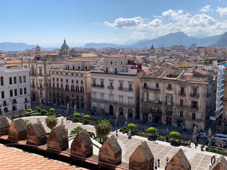 6 Days in Sicily Italy Itinerary shows view of Sicilian towns with a square and balcony buildings.