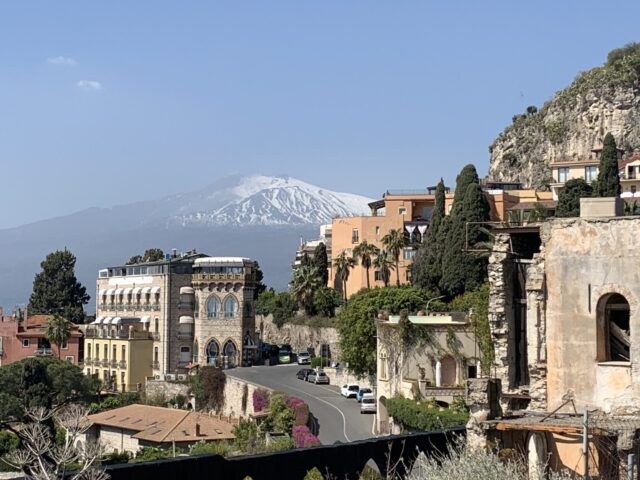 Older town area of Taormina with a view of Mount Etna beyond the town.