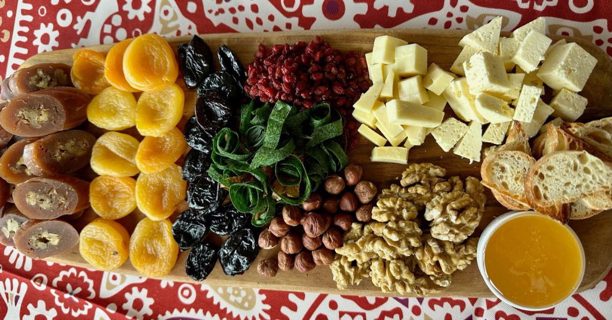 A traditional Georgian food board with bread, honey, cheese, local nuts, dried fruits and candies.