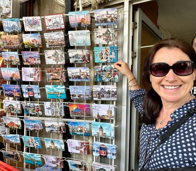 Woman tourist at a postcard stand