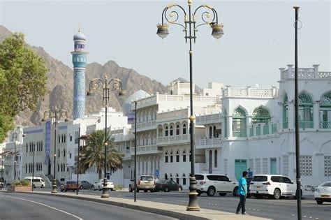 Central Muscat with white buildings, and wide streets.