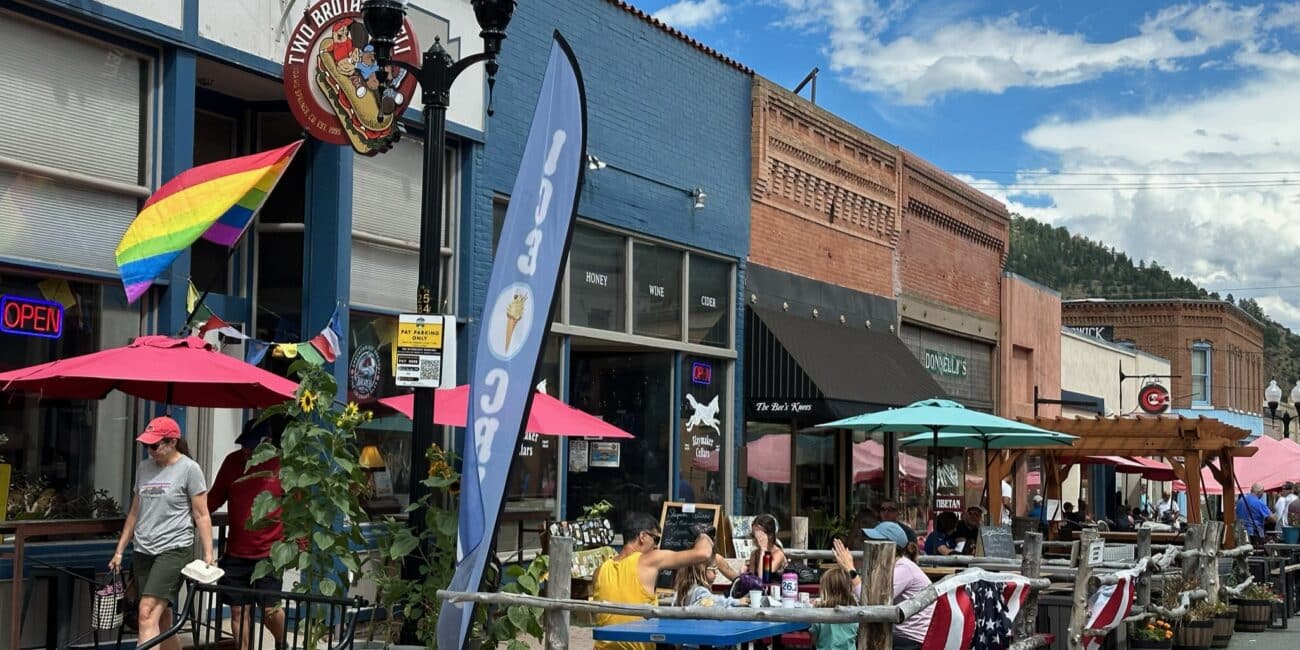 Idaho Springs Colorado. The town's Main Street sets out door tables for diners