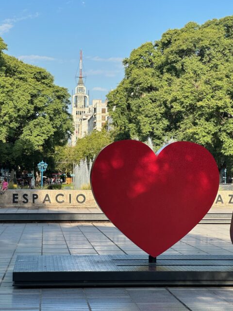 Where to Go October to December post showcases Medoza city main square with a large red heart welcome sign. Tree lined avenues are a feature of the city.
