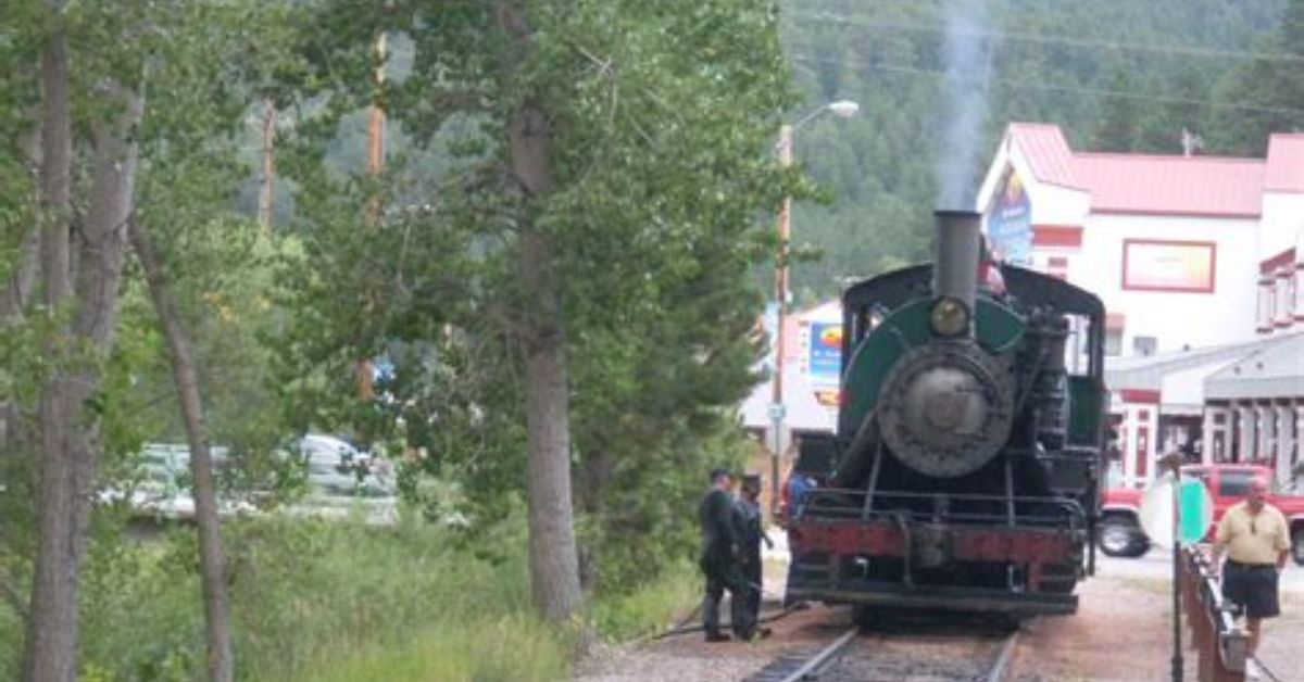 Steam train called 1880s has smoke puffing out of it.