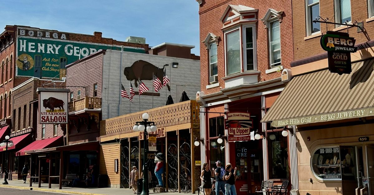 Downtown buildings with signs advertising saloon bars, shops in Deadwood South Dakota.
