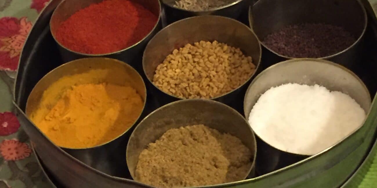 Small dishes of cooking ingredients include paprika, turmeric, Garlic, salt and pepper.