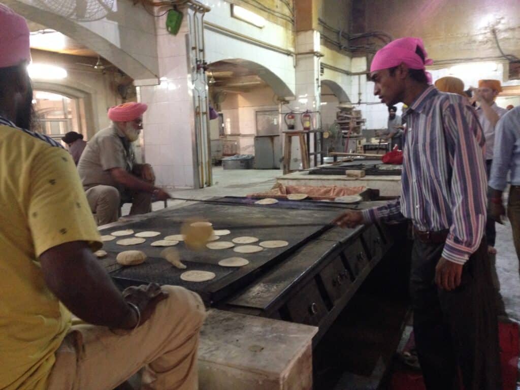 Men baking bread in a Sikh template in Delhi