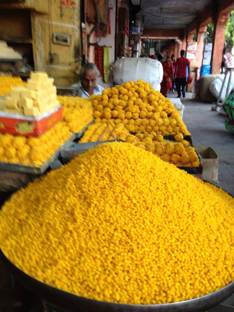 A large dish of ground flowers for sale in a city market in Jaipur.
