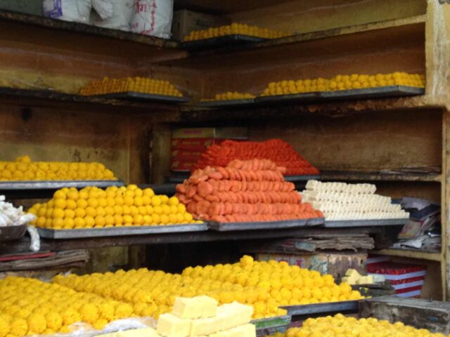 Street sweet treats in Jaipur market with yellow, orange and red cookies