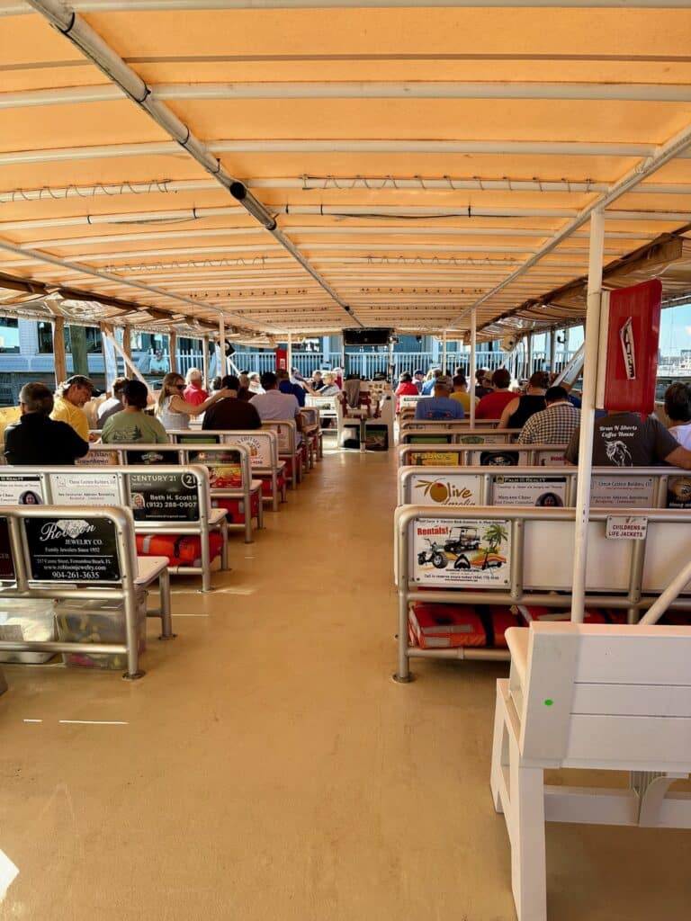 Take a cruise over the Georgia State Line from AmeliaIsland. This shows the boat deck with passengers enjoying the views.