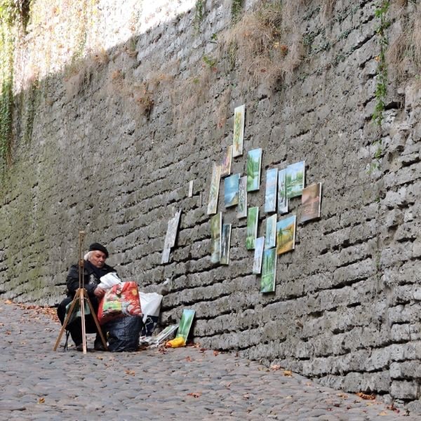 Artist has paintings hanging on the ancient walls of Tallinn