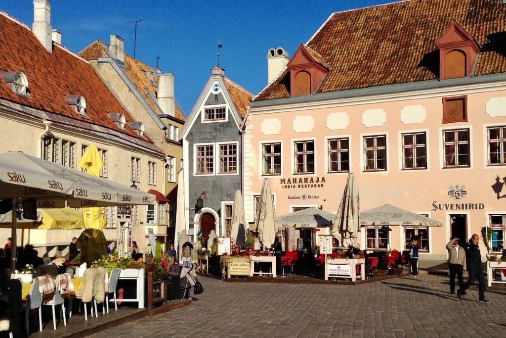 Square in Tallinn with old buildings and red tile roofs