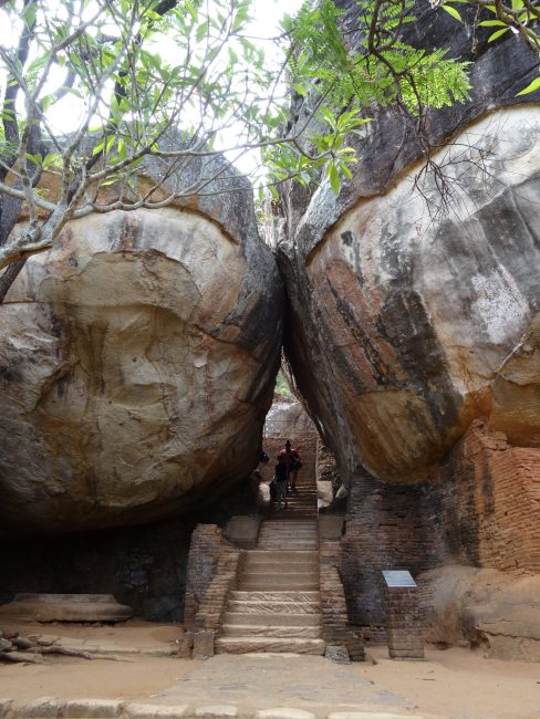 Stairs guide visitors between massive stone boulders.
